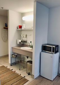 a small kitchen with a sink and a microwave at Urban Nest, Studio, Ground Floor in Halifax