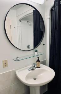 a bathroom with a sink and a mirror at Urban Nest, Studio, Ground Floor in Halifax