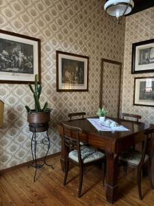 a dining room with a wooden table and chairs at B&B Chiara in San Sebastiano Curone