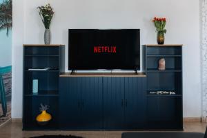 a tv on top of a entertainment center at Zima Two Seaside in Zygi