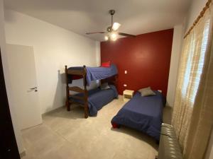 a bedroom with two bunk beds and a ceiling fan at Casa del lago in Termas de Río Hondo