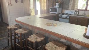 a kitchen with a counter top and stools in it at Casa Nostra in El Nihuil