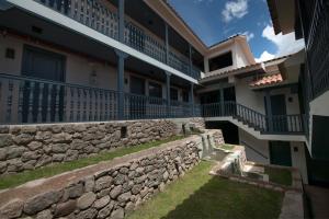 a building with a retaining wall and a stone wall at Motto By Hilton Cusco in Cusco