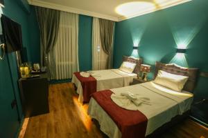 Postel nebo postele na pokoji v ubytování Sunlight Otel Fethiye