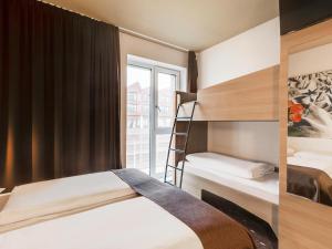 a bedroom with two bunk beds and a window at B&B Hotel Bremen-Überseestadt in Bremen