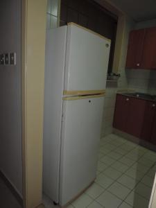 a white refrigerator in a small kitchen at Holiday homes in Dubai
