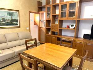 a living room with a table and a couch at Appartamento Saragozza in Bologna