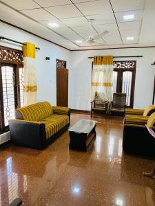 a living room with two couches and a coffee table at Villa Binna in Galle
