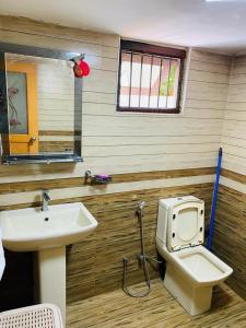 a bathroom with a toilet and a sink at Villa Binna in Galle