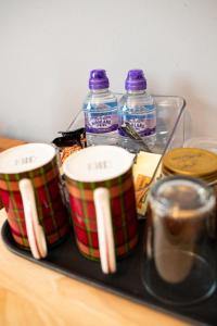 a tray with three cups and bottles of water at Fonthill Bed and Breakfast Nairn in Nairn