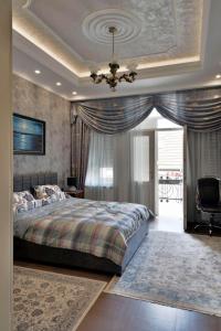 Un dormitorio con una cama grande y una lámpara de araña. en Zemun Center LUX 3 bedroom, en Belgrado