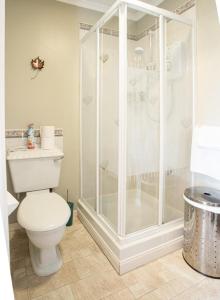 a bathroom with a shower and a white toilet at Fonthill Bed and Breakfast Nairn in Nairn