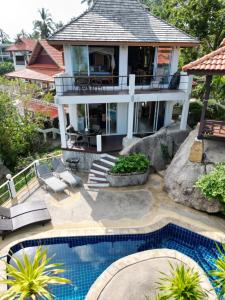 a house with a swimming pool in front of a house at Emerald Oasis Pool Villa Koh Tao in Ko Tao