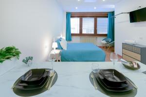 a bedroom with a bed and a table with chairs at LHE Les Trois Merveilles in Cesena
