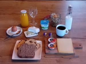 a table with a plate of bread and a cup of coffee at Boat & Breakfast Bellevue in Ghent