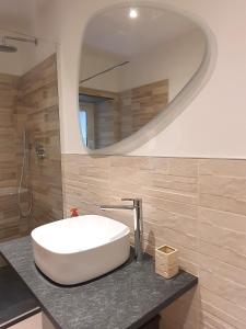 a bathroom with a white sink and a mirror at Il Giardino Segreto in Sestri Levante