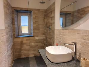 a bathroom with a white tub and a window at Il Giardino Segreto in Sestri Levante