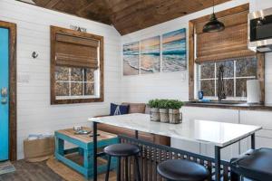 a kitchen with a sink and a counter with stools at Life's a Beach - 3 Acres with Hot Tub in Fredericksburg +29 photos