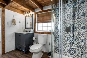 a bathroom with a toilet and a sink at Life's a Beach - 3 Acres with Hot Tub in Fredericksburg
