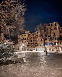 a large building at night with snow on the ground at Ca'Rosa in Venice