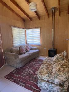 a living room with a couch and a rug at Cabañas Mili in Panguipulli