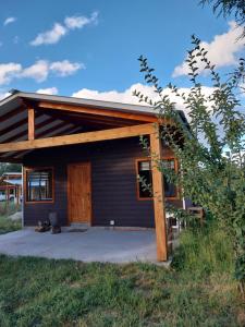 a cabin with a porch and a wooden door at Cabañas Mili in Panguipulli