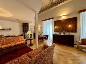 a living room with a couch and a table at Case Natoli - Residenze d'Epoca in Palermo