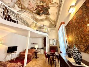 a living room with a spiral staircase and a living room at Case Natoli - Residenze d'Epoca in Palermo
