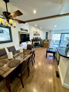 a living room with a table and chairs and a dining room at 1899- Knotty Pine - Big Bear Lake Retreat home in Big Bear Lake