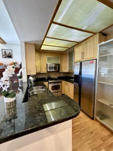 a kitchen with a sink and a refrigerator at 1899- Knotty Pine - Big Bear Lake Retreat home in Big Bear Lake