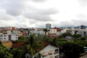 a view of a city with buildings and palm trees at La Défense Apart Hotel in Montes Claros