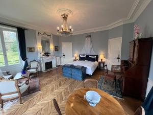 a living room with a bed and a table at Chateau du Gue aux Biches in Bagnoles de l'Orne