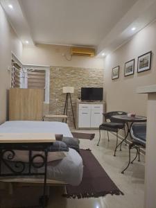 a room with a bed and a table and chairs at Golden Star Viktor in Zaječar