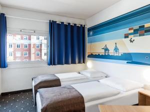 Postel nebo postele na pokoji v ubytování B&B Hotel Hamburg-Altona + 18 fotografií