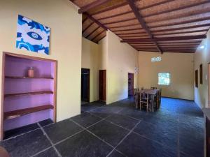 a large room with a table and chairs at Casa na lagoa azul in Cruz