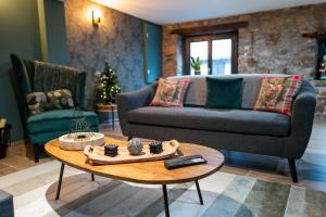 ein Wohnzimmer mit einem Sofa und einem Tisch in der Unterkunft Chalet Le René-Sens - 5 pers - Grande terrasse - bain nordique in Boutx
