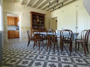 a kitchen with a dining room table and chairs at Chateau Magondeau in Saillans