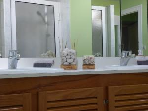 a bathroom with two sinks and two mirrors at Chateau Magondeau in Saillans