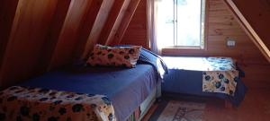 Postel nebo postele na pokoji v ubytování Hostal El Colibri