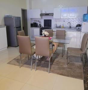 a kitchen with a dining room table and chairs at the perfect affordable apartments in Nairobi