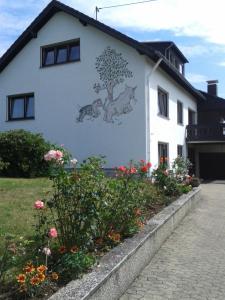 a building with a mural of pigs on the side of it at Ferienwohnung Fülbier in Oberzissen