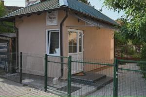 a small house with a fence in front of it at Golden Star Viktor in Zaječar