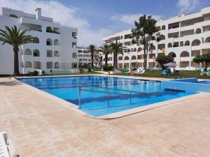 a large swimming pool in front of a building at Casa Limão - Senhora da Rocha, Algarve in Porches