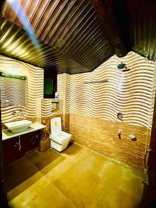 a bathroom with a toilet and a sink at Main Street Inn in Srinagar