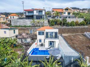 an aerial view of a house with a swimming pool at Blue Ocean Villa in Ponta do Sol