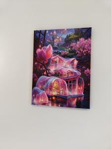 a painting of a pink house with lights at Apartamento Sebastian in Lisbon