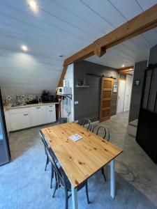 a kitchen with a wooden table and chairs at LE CHALET in Gavarnie