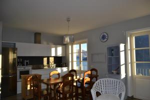 a kitchen with a dining room table and chairs at Solivonatural Apartment in Cannobio