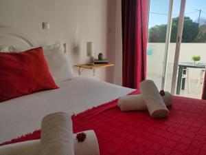 a bedroom with a bed with towels on it at Vicentina Rooms by Casas do Alentejo in Almograve