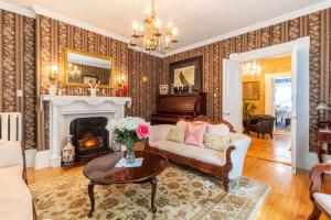 a living room with a couch and a fireplace at The Dawson House Bed & Breakfast in Charlottetown